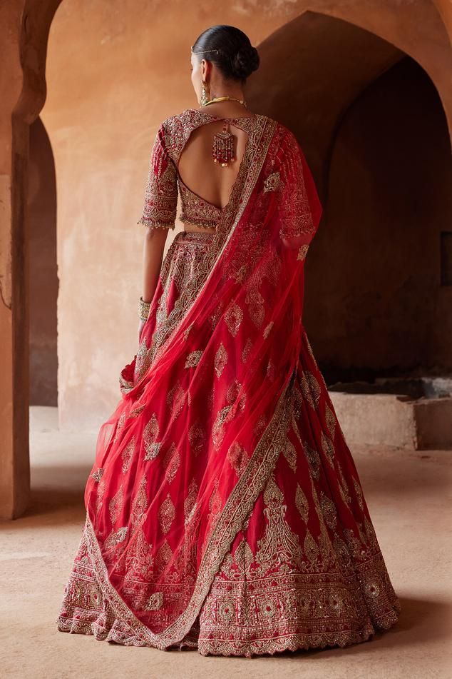 Cardinal red attached cancan lehenga with gold dabka, zari, sequin, bead, crystal embroidery in floral pattern. Paired with embroidered padded blouse and dupatta.
Components: 3
Pattern: Embroidery
Type Of Work: Dabka, zari, sequin, bead, crystal
Neckline: Notched
Sleeve Type: Three quarter
Fabric: Raw Silk, Net
Color: Red
Other Details: 
Lehenga:
Attached cancan
Floral pattern
Length: 45 inches
Blouse:
Padded
Bead drops on hem
Back cut-out
Tassel detailing at the back
Dupatta:
Embroidered scallo Coral Ombre, Crystal Work, Raw Silk Lehenga, Indian Women Painting, Crystal Embroidery, Coral Blouse, Bridal Lehenga Red, Padded Blouse, Indian Wedding Wear