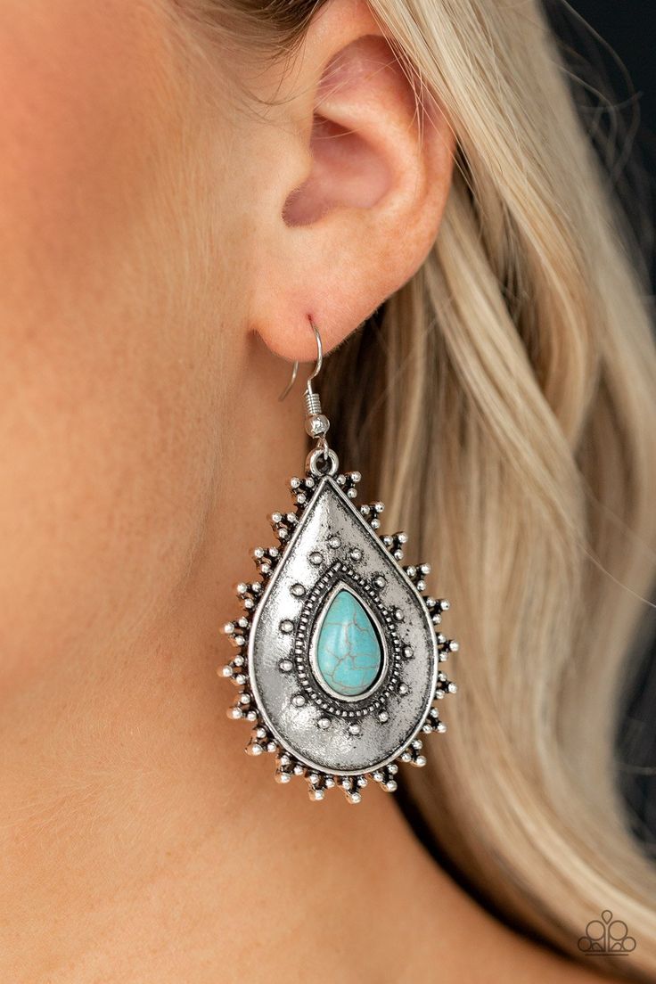 Chiseled into a tranquil teardrop, a refreshing turquoise stone is pressed into the center of an antiqued silver teardrop dotted in shimmery silver studs for a seasonal look. Earring attaches to a standard fishhook fitting. Sold as one pair of earrings. Celebrity Engagement Rings, Paparazzi Accessories, Paparazzi Jewelry, Blue Earrings, Fish Hook, Silver Earrings Studs, Turquoise Stone, Silver Studs, Free Jewelry