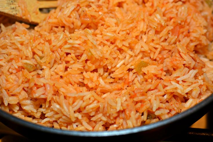 a pan filled with cooked rice on top of a stove