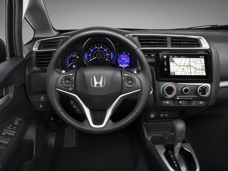 the interior of a car with steering wheel, dashboard and infotains on display