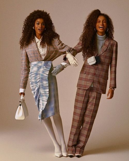 two women dressed in plaid outfits and white gloves