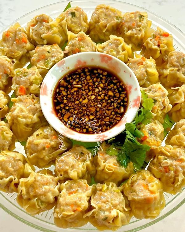 a plate filled with dumplings and dipping sauce