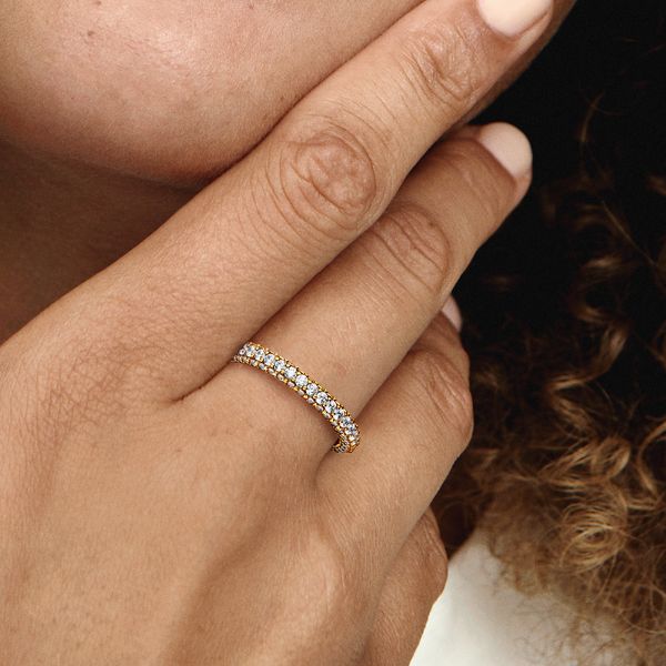 Stackable, radiant, timeless. Shining in 14k gold plating, our hand-finished Pandora Timeless Pavé Single-row Ring features one row of clear cubic zirconia around the center and one row facing outwards around each side, creating a slightly rounded square profile that sparkles from every angle. Style it on its own or with other Timeless Pavé pieces to create as much of a minimalist or maximalist effect as you want. - Pandora Timeless Pavé Single-row Ring - 14k Gold-plated unique metal blend / Cubic Zirconia / Clear - Sz. 8.5 Gold Cubic Zirconia Diamond Ring With Sparkling Detail, Classic Gold Sparkling Rings, Classic Sparkling 14k Gold Jewelry, Sparkling 14k White Gold Jewelry, Diamond Rings In Yellow Gold With Sparkling Details, Yellow Gold Diamond Rings With Sparkling Details, Sparkling Diamond Rings In Yellow Gold, Elegant Sparkling Yellow Gold Jewelry, Refined Jewelry With Radiant Cut Vvs Clarity