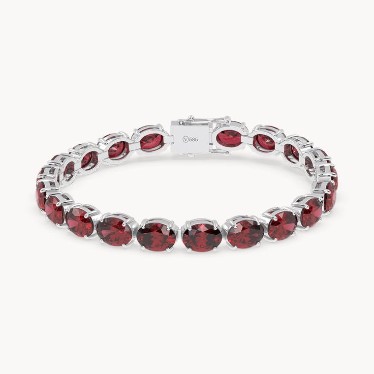 The Rouge Tennis Bracelet celebrates the passionate power of the ruby, with its deep red color reminiscent of a glowing fire. Crafted from 14kt recycled gold, the bracelet is set with oval cut rubies elegantly held in prong settings. With an impressive total carat weight of 36ct. and an intense red hue, each stone embodies passion and strength. This piece, with a width of 6 mm, is a true eye-catcher and a symbol of the fiery elegance of rubies. Red Oval Tennis Bracelet Fine Jewelry, Red Oval Fine Jewelry Tennis Bracelet, Luxury Red Oval Bracelet, Classic Red Oval Diamond Bracelet, Red Oval Diamond Classic Bracelet, Red Oval Classic Diamond Bracelet, Red Oval Diamond Gemstone Bracelet, Formal Ruby Oval Tennis Bracelet, Red Oval Diamond Bracelet Gift