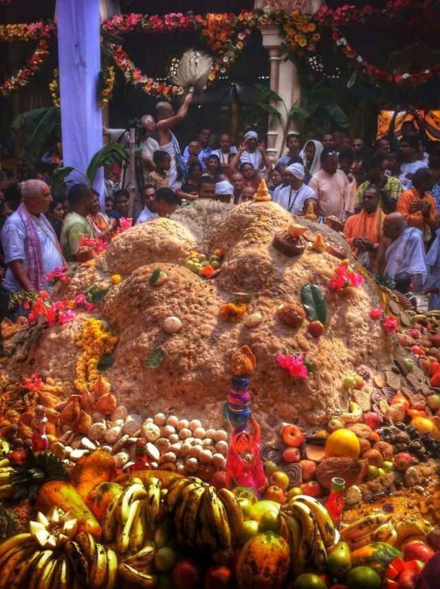 a large pile of food sitting on top of a table covered in fruits and vegetables