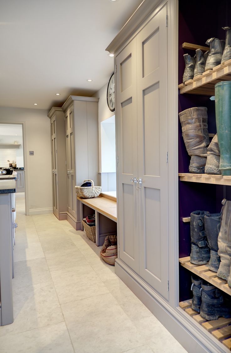 there are many boots on the shelves in this room, and one is blue with white trim