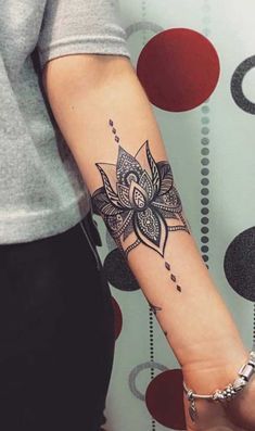 a woman's arm with a tattoo on it and a flower in the middle