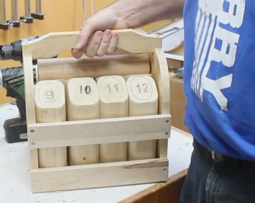 a man is working with wooden blocks on a table