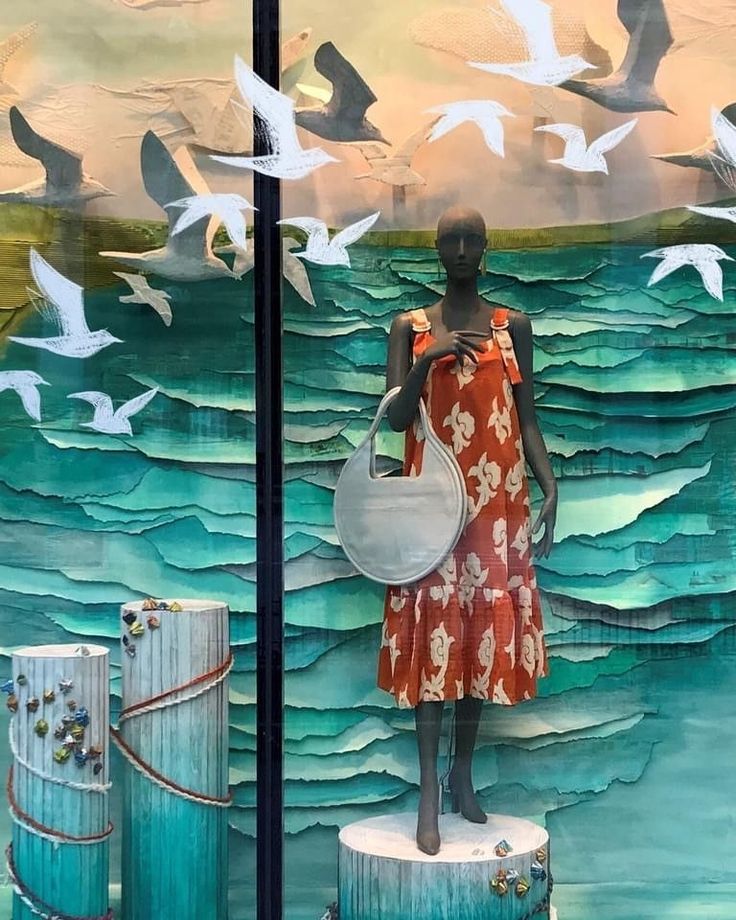 there is a mannequin in front of a window with birds flying over the water