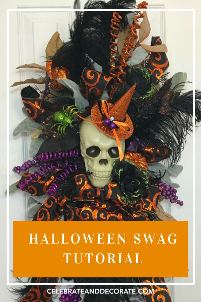 halloween swag wreath with a skeleton wearing a witches hat and orange, black and green feathers