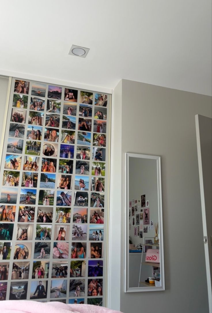 a bedroom with pictures on the wall and a mirror in front of it that has been decorated with photos