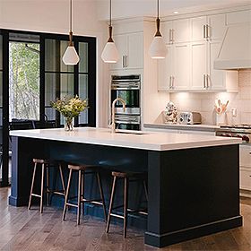 an instagramted photo of a kitchen with white cabinets and black island