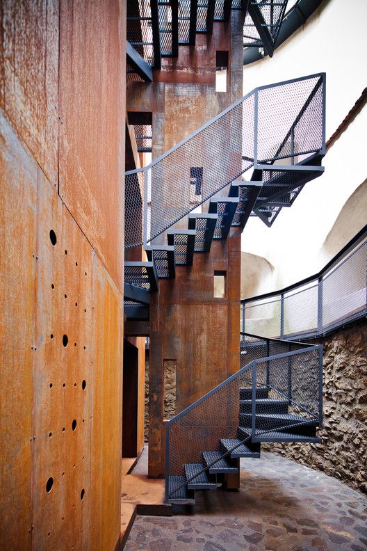 an image of a spiral staircase going up the side of a building with metal railings