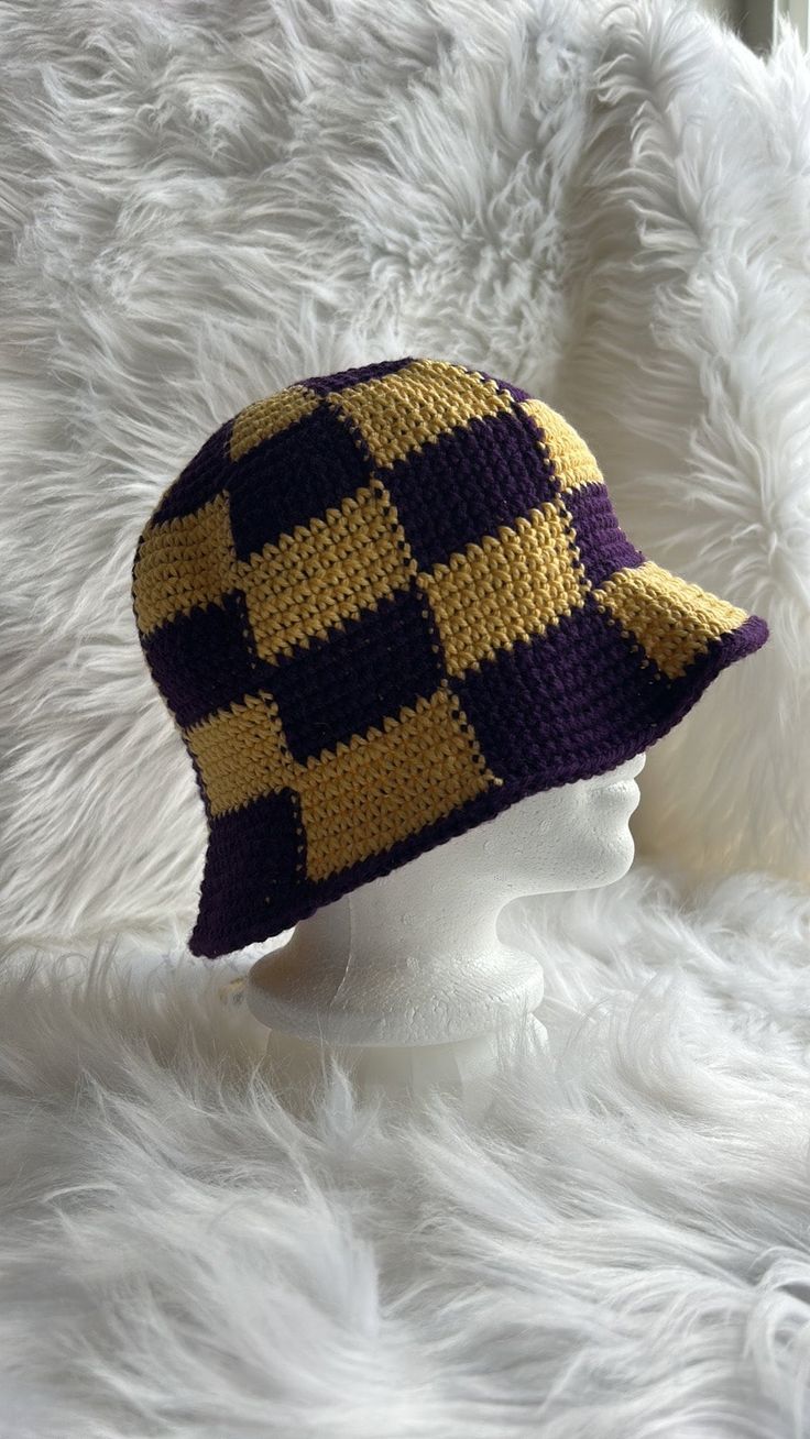 It's summertime and that means time for a nice cool bucket hat! This really fun checked bucket hat is done in a purple and yellow coloration - University of Washington Huskies colors. A very striking hat made with 100% cotton yarn that will ensure your comfort in the warm weather and protect your head from the suns hot rays. Yellow Cotton Bucket Hat With Short Brim, Casual Purple Crochet Bucket Hat, Casual Purple Cotton Bucket Hat, Handmade Yellow Cotton Hats, Trendy Purple Bucket Hat With Curved Brim, Yellow Brimmed Cotton Bucket Hat, Trendy Purple Bucket Hat, Casual Handmade Yellow Bucket Hat, Yellow Cotton Brimmed Bucket Hat