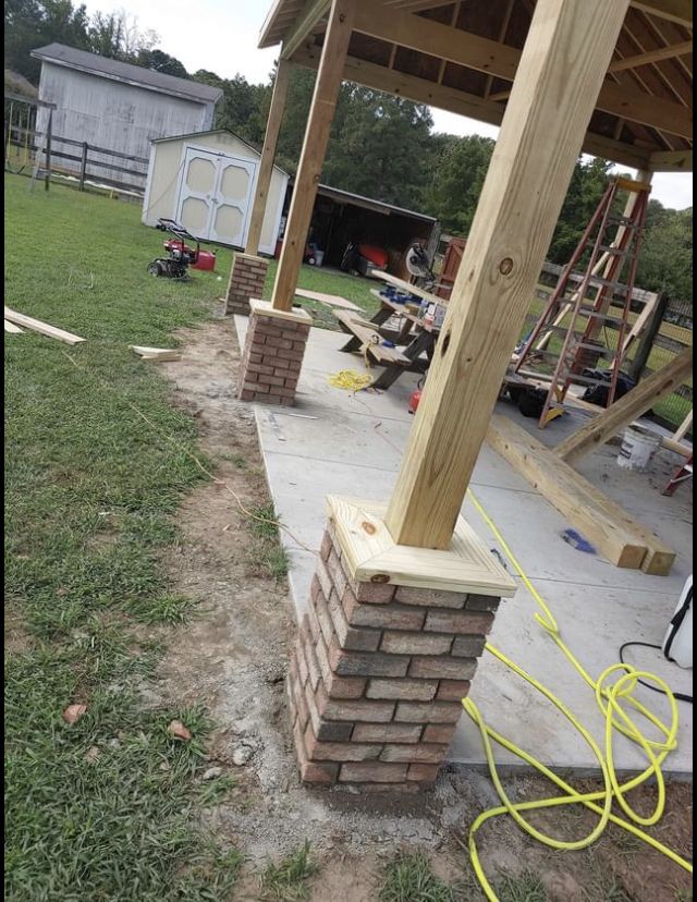 some bricks are stacked on top of each other to form a fire place in the back yard