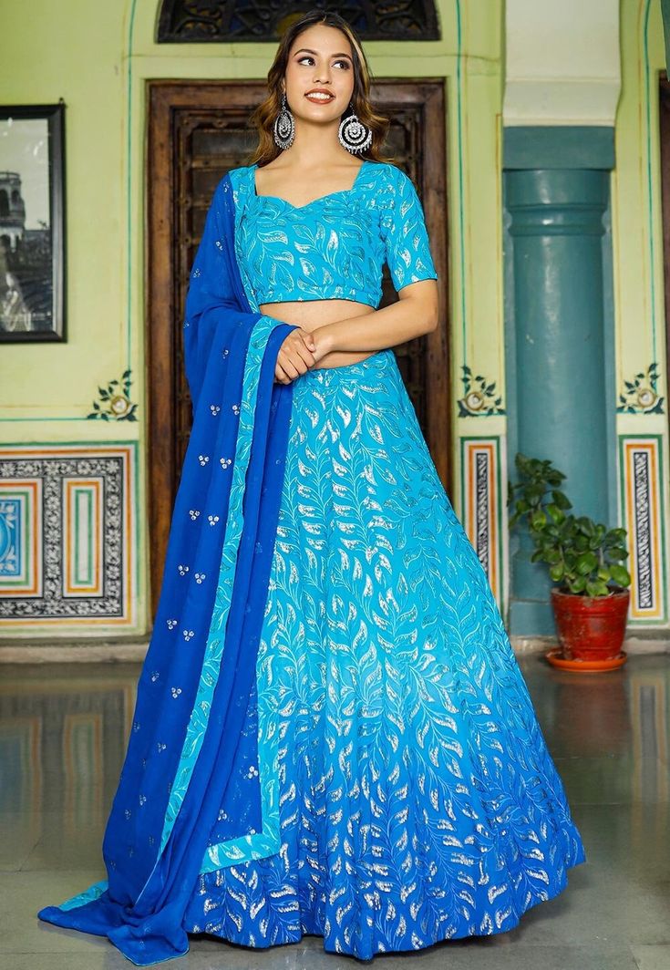 Readymade Faux Georgette Lehenga in Shaded Blue. This attire with Shantoon and Cotton Lining is Enhanced with Fancy Tassels, Resham and Sequins WorkAvailable with a Faux Georgette Blue Choli Crafted in Sweetheart Neck and Half Sleeves and a Faux Georgette Dupatta in Royal Blue. The Choli and Lehenga Lengths are 14 and 42 inches respectively. Do Note: Accessories shown in the image are for presentation purposes only. (Slight variation in actual color vs. image is possible). We sell all kinds of L Blue Sequined Sets For Reception, Blue Sequined Saree Traditional Wear, Fitted Blue Sets With Resham Embroidery, Festive Blue Fitted Sets, Blue Georgette Sets With Unique Design, Blue Georgette Saree Set, Blue Georgette Dress With Pallu, Fitted Blue Dupatta For Festivals, Semi-stitched Bollywood Style Blue Sets