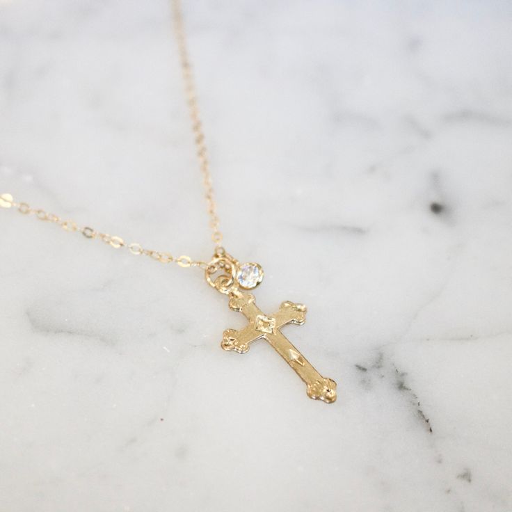 A beautiful mid size, 14k gold filled ornate detailed cross charm on a 14k gold filled chain. With or without a simulated diamond charm. 17-18.5 inch length. *Gold filled jewelry is the next best thing to solid gold. It's great for sensitive skin plus you don't have to worry about it flaking off, changing color or irritating your skin. Gold Cross Necklace With Dainty Chain, 14k Gold Cross Necklace For Spiritual Wear, Dainty 14k Gold Cross Jewelry, Dainty 14k Gold Cross Necklace, Dainty 14k Gold Cross Necklace For Everyday, Dainty 14k Gold Cross Necklace With Delicate Chain, Dainty Everyday 14k Gold Cross Necklace, Delicate Gold Cross Jewelry, Gold Cross Birthstone Jewelry