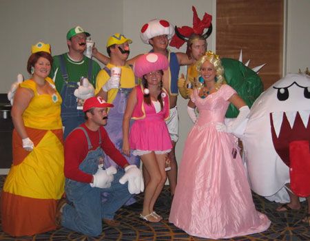 a group of people in costumes posing for a photo