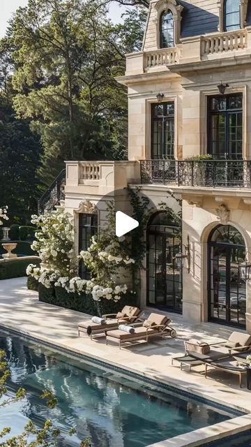 a house with a pool in front of it and lots of windows on the side