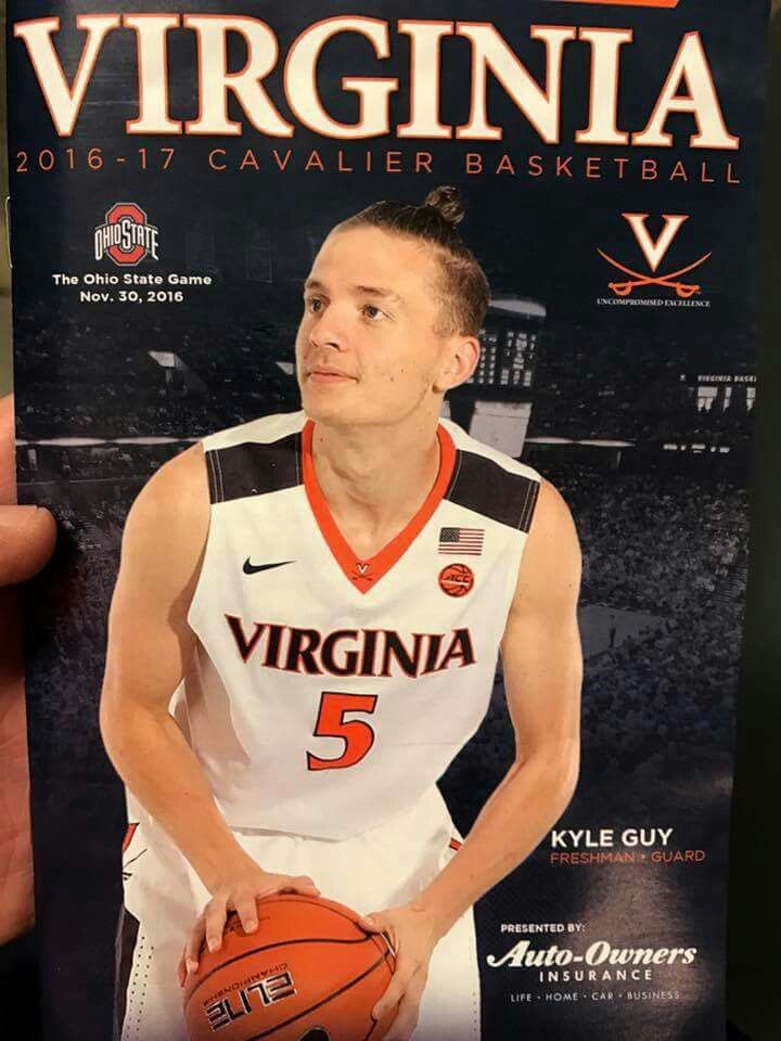 a man is holding up a basketball card for the virginia v - cavillier basketball game