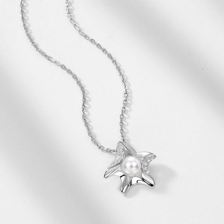 Description & Details Embrace the beauty of the sea with our meticulously crafted pieces that capture the essence of starfishes in stunning detail. From elegant starfish pendants to intricate starfish necklaces, our collection offers a range of styles to suit your unique taste. • Material: Solid 925 Sterling Silver ∙ Pearl ∙ Cubic Zirconia • Finish: Hypoallergenic ∙ Gold Plating•Dimensions: 40 - 45 cm chain , adjustable• All our work is custom made by hand with love Elegant Starfish Charm Jewelry For Gifts, Elegant Starfish Charm Jewelry As Gift, Elegant Starfish Charm Jewelry Gift, Ocean-inspired Star Necklaces For Gifts, Elegant Silver Starfish Jewelry, Elegant Starfish Necklace For Gift, Elegant Sterling Silver Jewelry With Starfish Charm, Elegant Silver Star Charm Necklaces, Elegant Silver Necklace With Star Charm