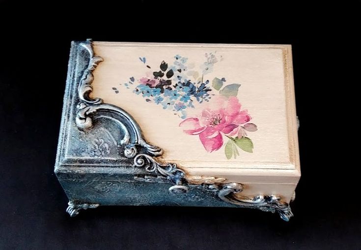 an old box with flowers painted on it