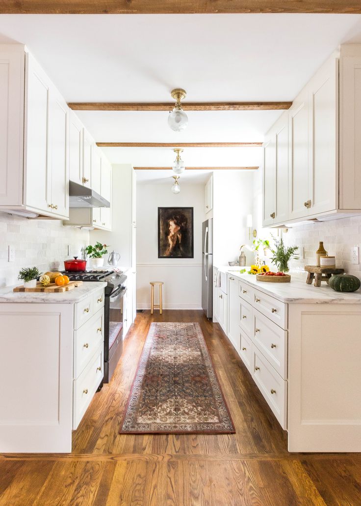 the kitchen is clean and ready for us to use it's white cabinetry