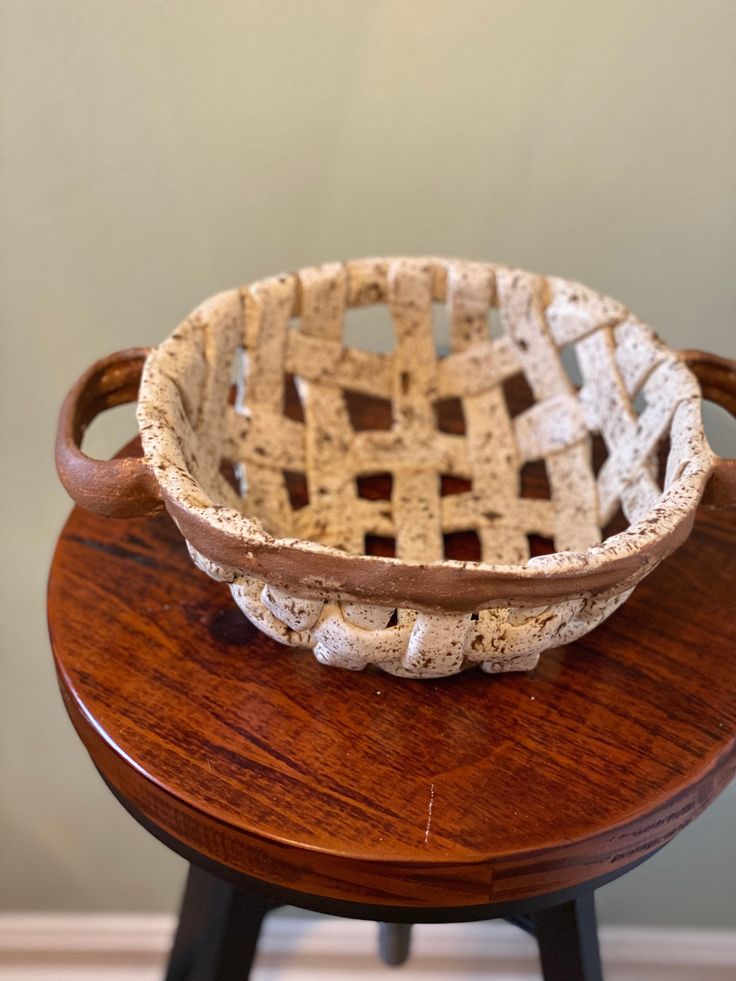 a bowl sitting on top of a wooden table