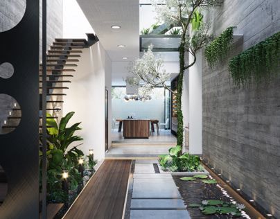 an entry way leading to a living room and dining area with potted plants on either side