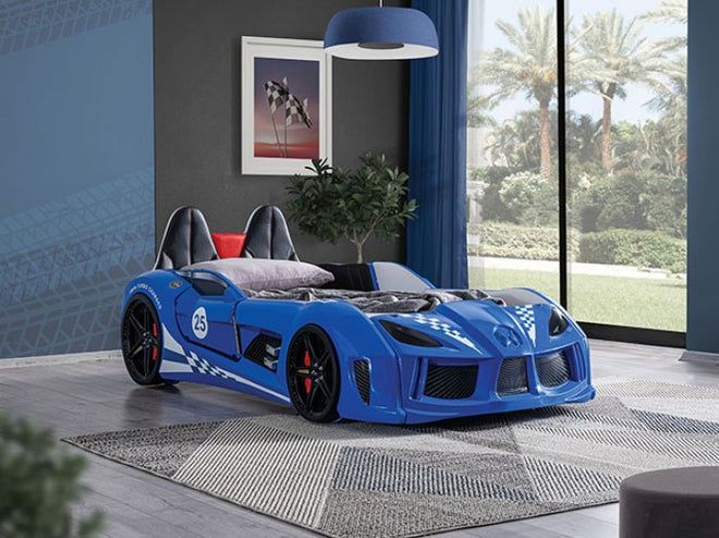 a blue sports car bed sitting in a bedroom