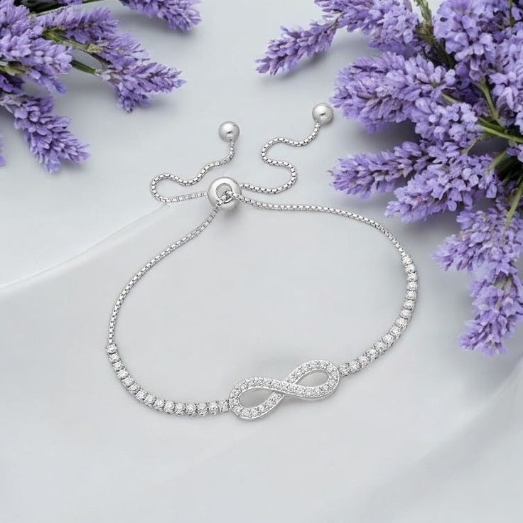 Elegance redefined with our 925 Sterling Silver Infinity Bracelet adorned with sparkling CZ diamonds. Adjustable to fit perfectly. Elegant Infinity Diamond Bracelet For Formal Occasions, Elegant Infinity Bracelets For Wedding, Elegant Wedding Infinity Bracelets, Elegant Infinity Cubic Zirconia Jewelry, White Gold Infinity Cubic Zirconia Jewelry, Elegant Sterling Silver Diamond Bracelet For Party, White Gold Infinity Jewelry With Cubic Zirconia, Adjustable Infinity Bracelet For Formal Occasions, Sterling Silver Cubic Zirconia Bracelet For Party