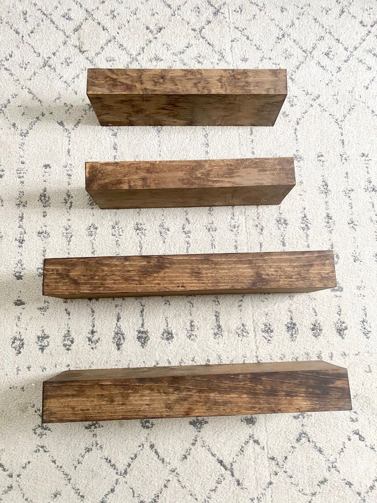 three pieces of wood sitting on top of a rug