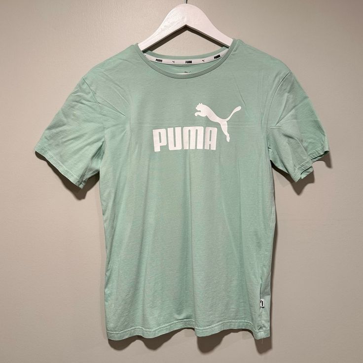 New Without Tags Mint Green Puma Logo T-Shirt. Size Small. 100% Cotton. Approx. Measurements (Laying Flat): Length (Shoulder To Hem): 24.5” Pit To Pit: 18” Comes From A Smoke Free, Cat Friendly Home. Please Ask All Questions About An Item Before Making An Offer. Offers Are Welcome! Bundle For The Best Deal! Thanks For Checking Out My Closet! Green Logo Print Athleisure T-shirt, Green Athleisure T-shirt With Logo Print, Casual Cotton T-shirt With Puma Logo, Puma Logo Cotton Short Sleeve Top, Puma Logo Cotton Top For Streetwear, Cotton Puma Logo Top For Streetwear, Casual Puma Logo Short Sleeve Top, Puma Cotton Top For Streetwear, Short Sleeve Cotton Top With Puma Logo