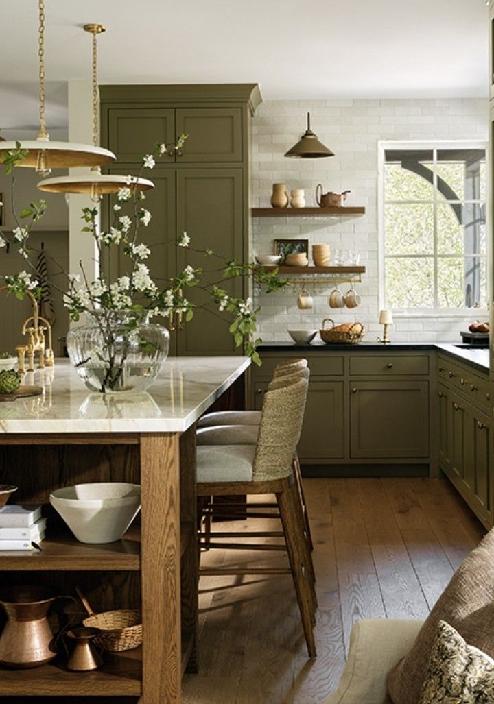 the kitchen is clean and ready to be used for cooking or baking, with green cabinetry