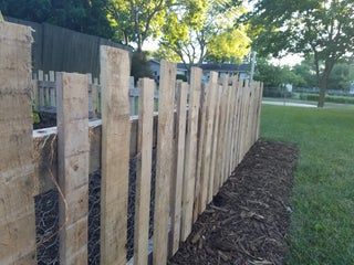 a wooden fence is shown in the grass