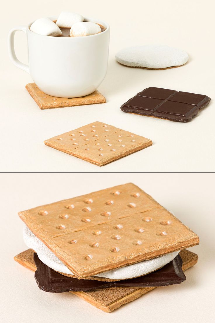 there are cookies, marshmallows and chocolate on top of each other next to a cup of coffee