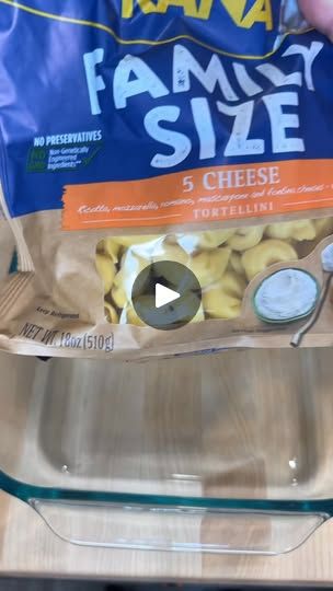 a bag of frozen food sitting on top of a counter next to a person's hand