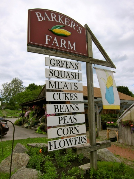 a sign for a farmer's farm in front of a building