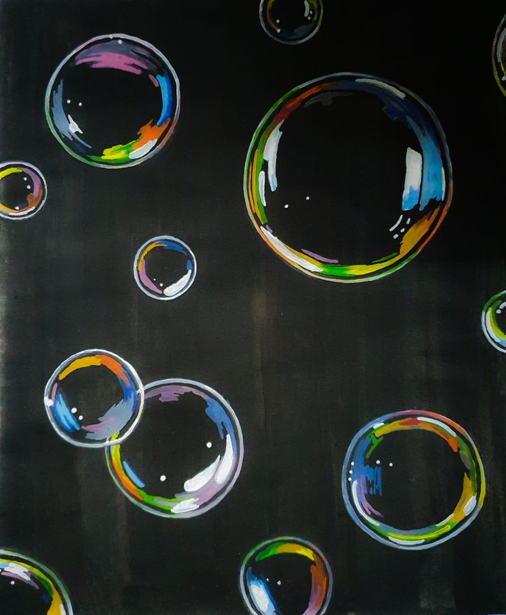 soap bubbles are floating in the air on a black surface with multicolored circles