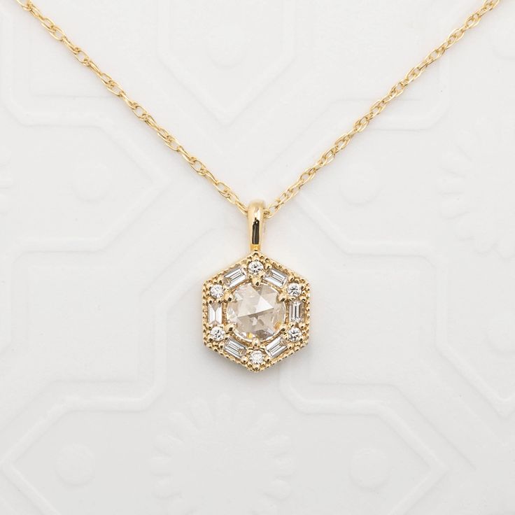 "Can be purchased as a pendant charm only or with rope chain necklace. Earth mined natural rose cut diamond necklace set in art deco inspired hexagon setting using baguette and round brilliant diamonds. Hexagon charm size: 9.5mm wide Approx. 0.14ct white accent diamonds Made of recyclable solid gold and ethically sourced gemstones If purchased as a necklace, comes with a rope chain with adjustable lengths at 18\" and 20\"." Luxury Teardrop Pendant Necklace With Rose Cut Diamonds, Art Deco Pendants, Art Deco Pendant Jewelry With Single Cut Diamonds, Art Deco Single Cut Diamond Pendant Jewelry, Art Deco Single Cut Diamond Pendant, Art Deco Style Single Cut Diamond Pendant, Art Deco Necklace With Single Cut Diamonds As Gift, Art Deco Necklace With Single Cut Diamonds For Gift, Art Deco White Gold Necklace With Rose Cut Diamonds