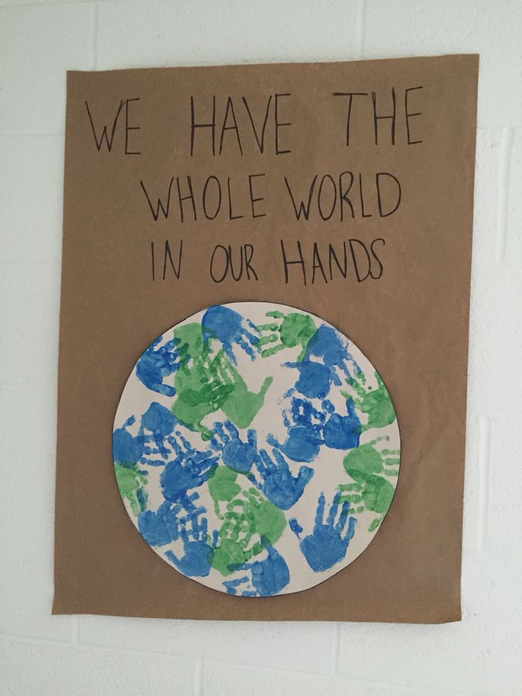 a paper plate with hand prints on it that says we have the whole world in our hands