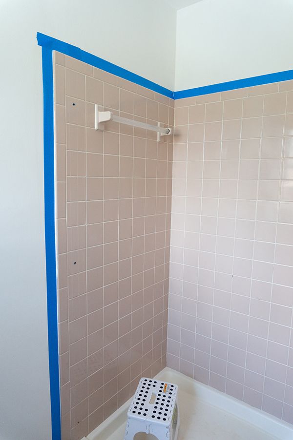 a white toilet sitting in a bathroom next to a walk in shower with blue trim on the walls