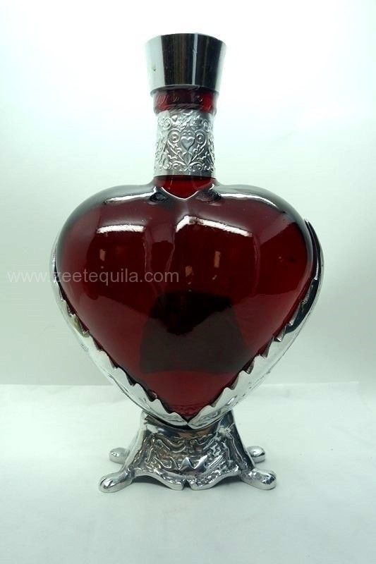 a heart shaped glass bottle with a silver base on a white background, in the shape of a vase