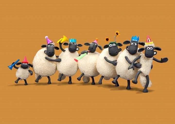 a group of sheep with party hats and streamers in the shape of birthday candles