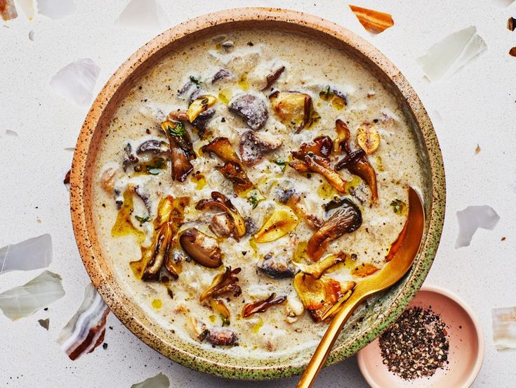 a bowl filled with soup next to a spoon