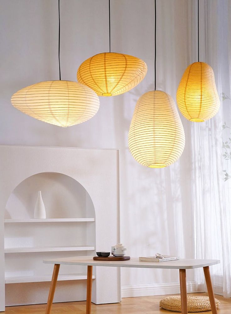 three lamps hanging over a table in a room