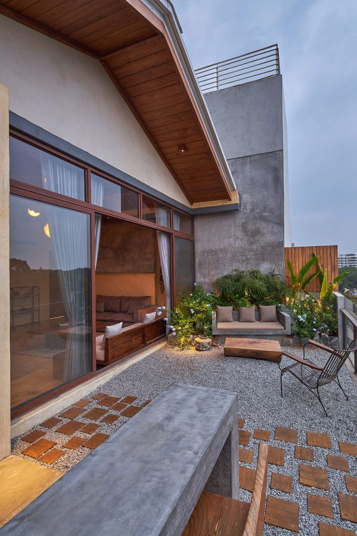 an outdoor living area with patio furniture and potted plants