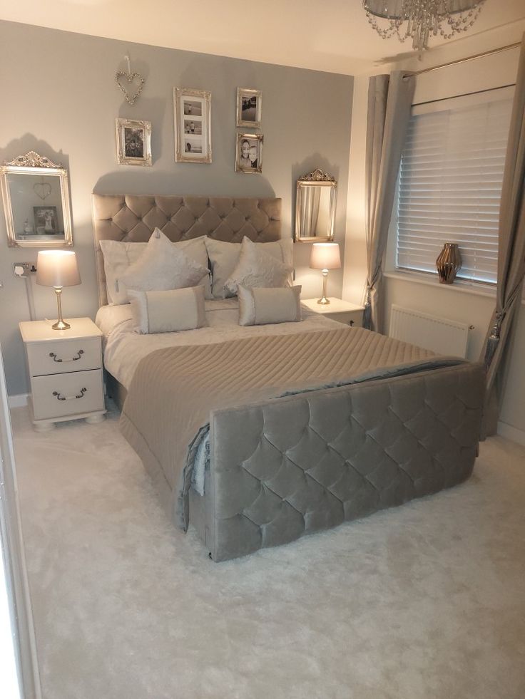 a bedroom with a bed, nightstands and pictures on the wall