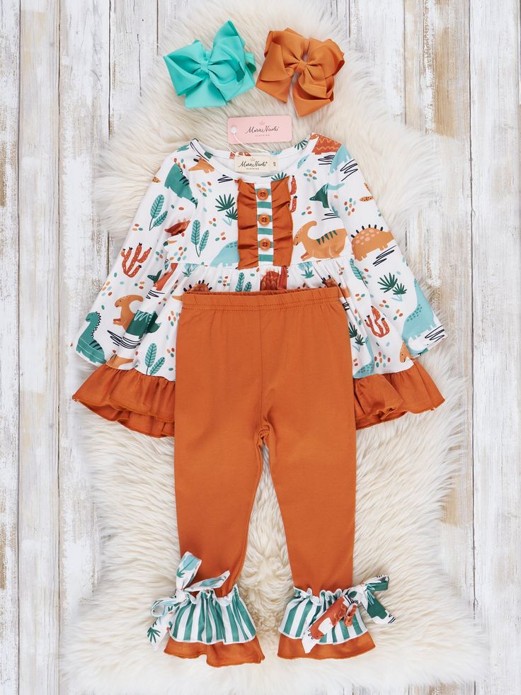 Get ready to roar with this dino-mite sister set! This playful girls outfit features a ruffle hem top adorned with a cute dinosaur print. The coordinating ruffle leggings complete the look so she's ready for her next adventure. Fits true to size. Body: 95% Polyester / 5% Spandex Combo: 97% Cotton / 3% Spandex Accessories sold separately. Suggest bow color #12 #47 Import. *Afterpay and Sezzle Purchase Requires $35 Minimum Order. Ruffle Outfit, Ruffle Leggings, Cute Dinosaur, Hem Top, Dinosaur Print, Ruffle Hem, Girl Outfits, Leggings, Sewing