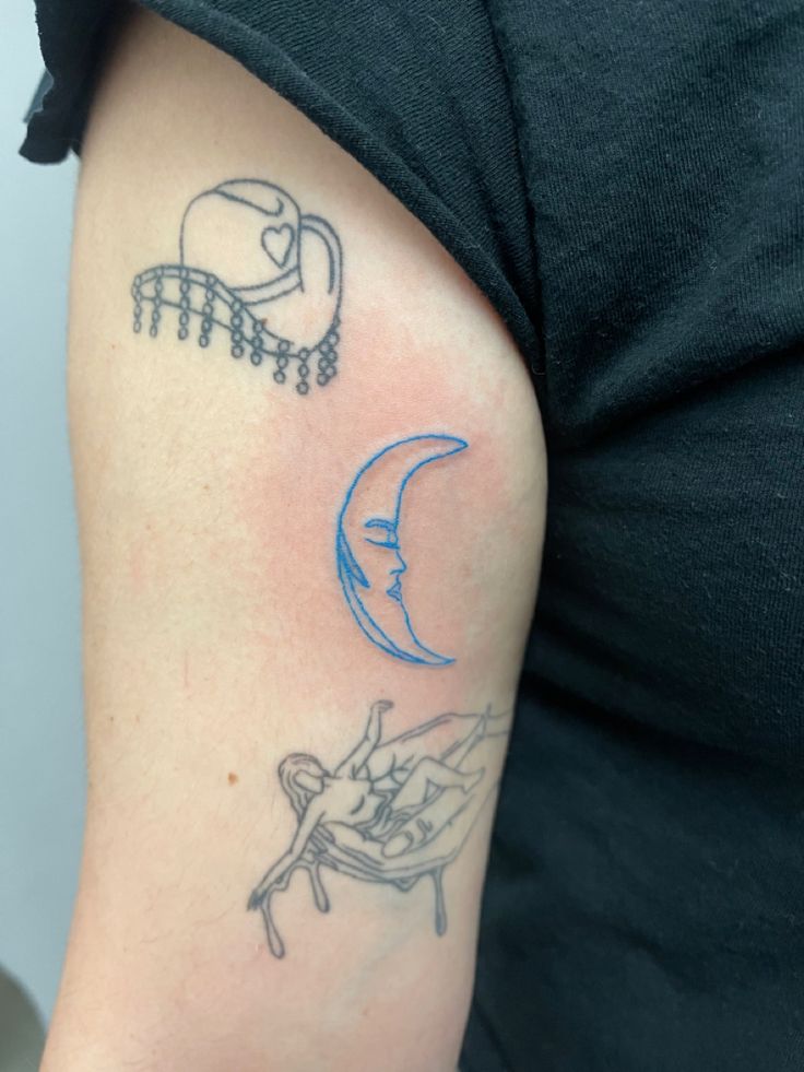 a woman's arm with tattoos on it, including a chair and a half moon